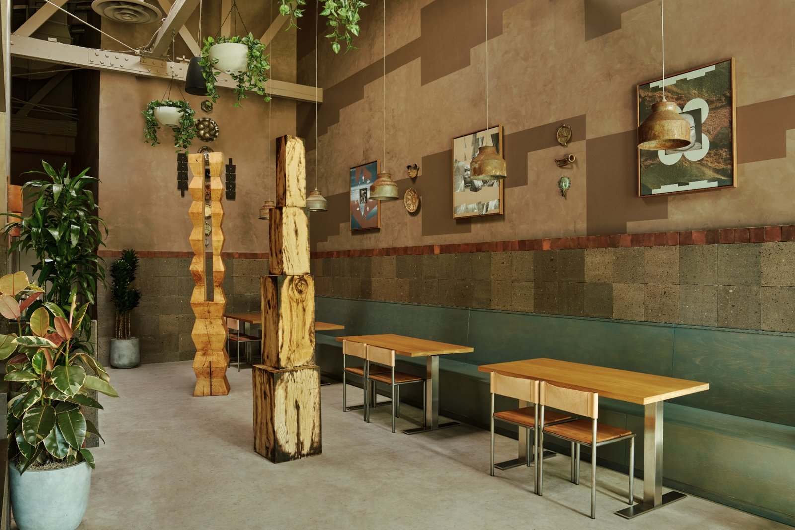 LOQUI dining room with hanging plants, wooden sculptures, and green banquette seating