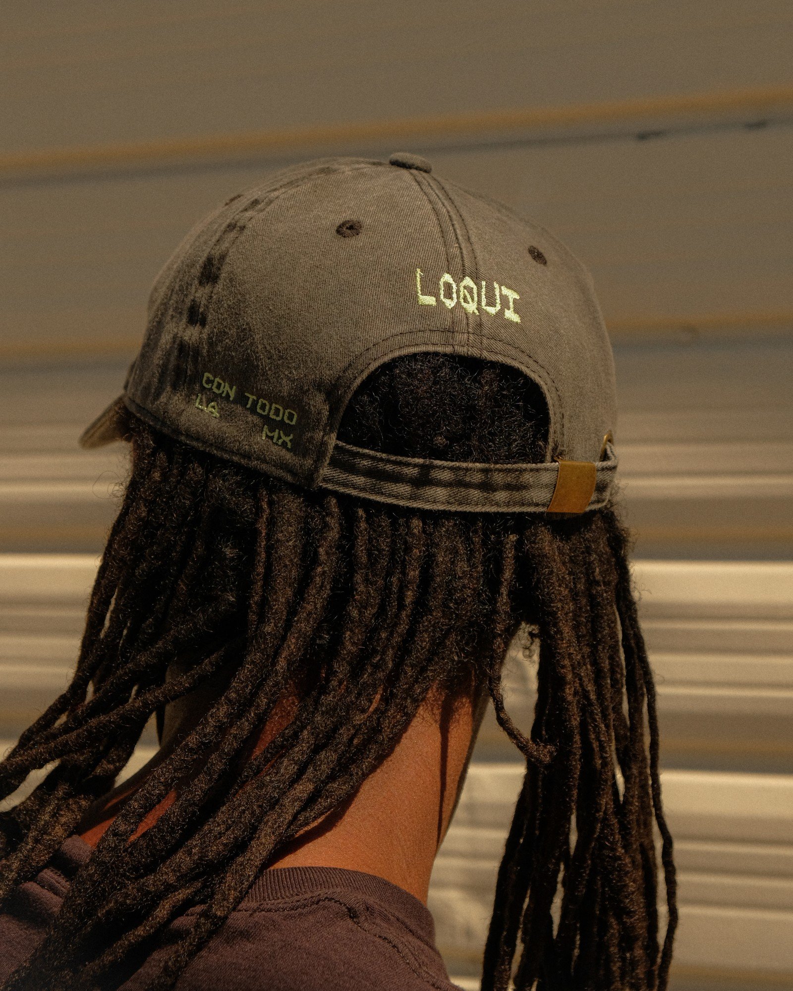 Back of a LOQUI cap with embroidered lettering