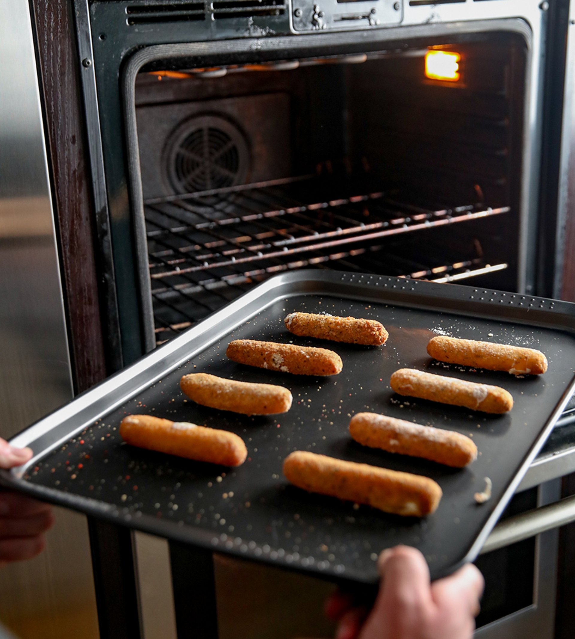 Mozzarella sticks on an oven tray