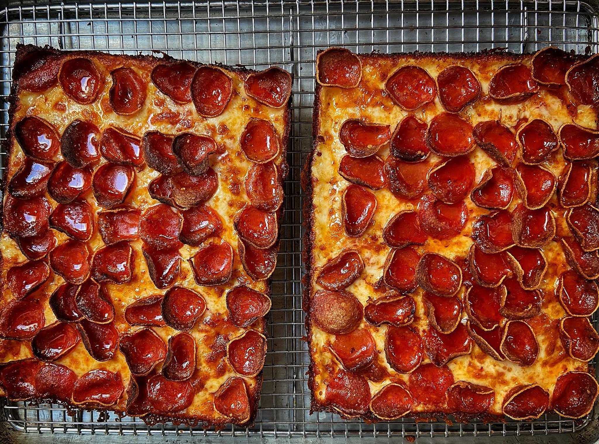 Pepperoni Detroit-style pizzas on a wire rack