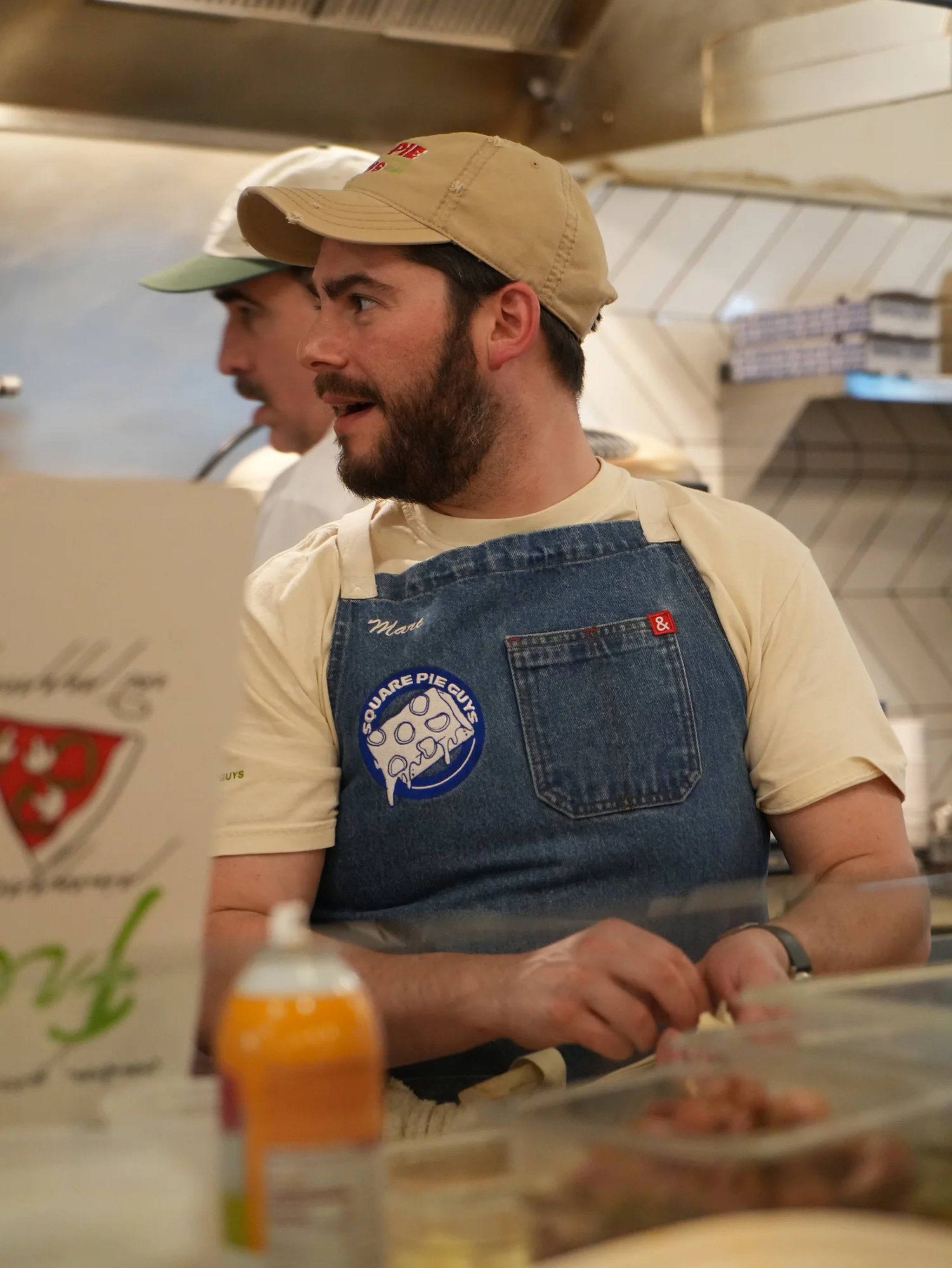 Founder Marc Schechter working the line in a Square Pie Guys apron
