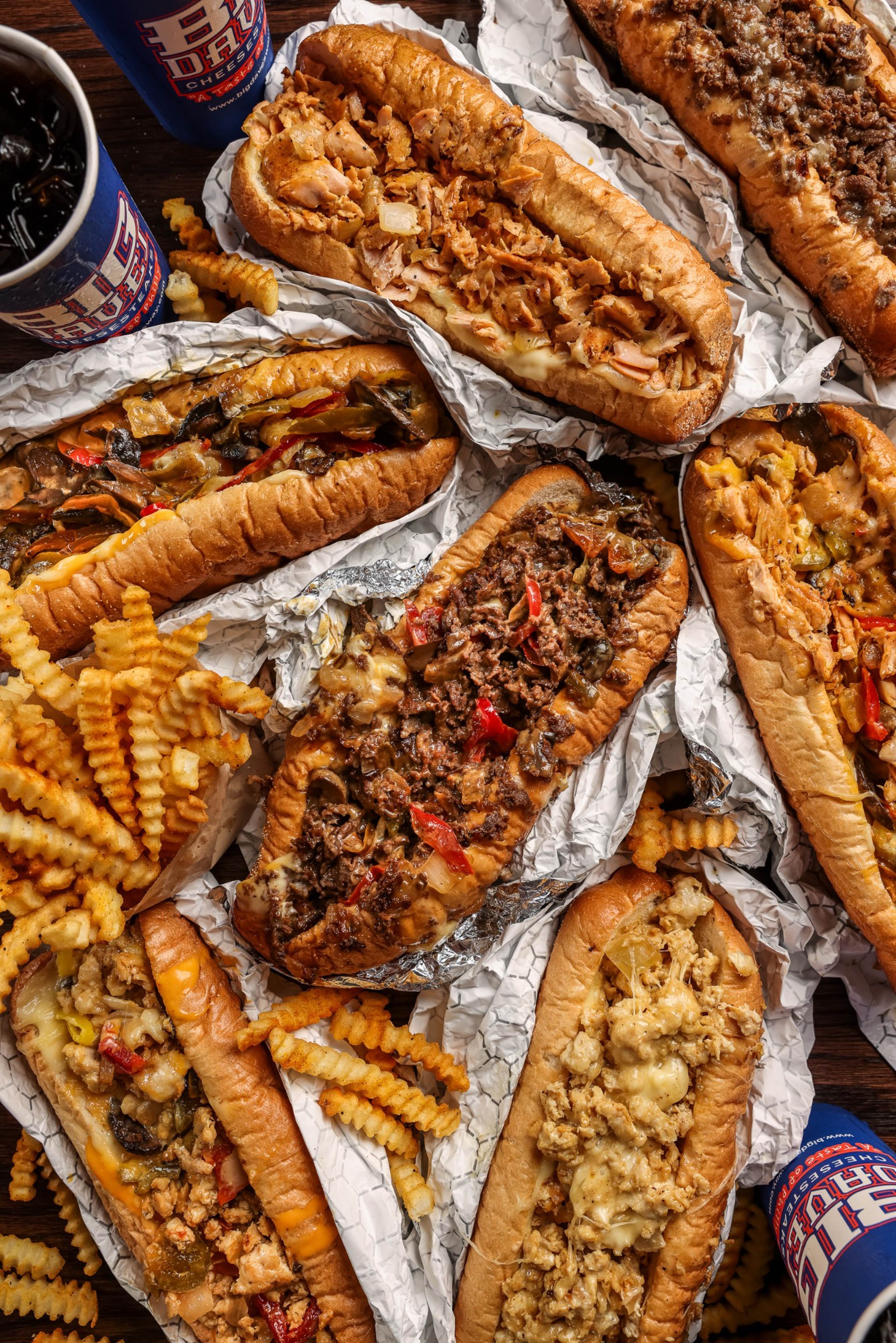 A spread of Big Dave's cheesesteaks and crinkle-cut fries laid out for catering