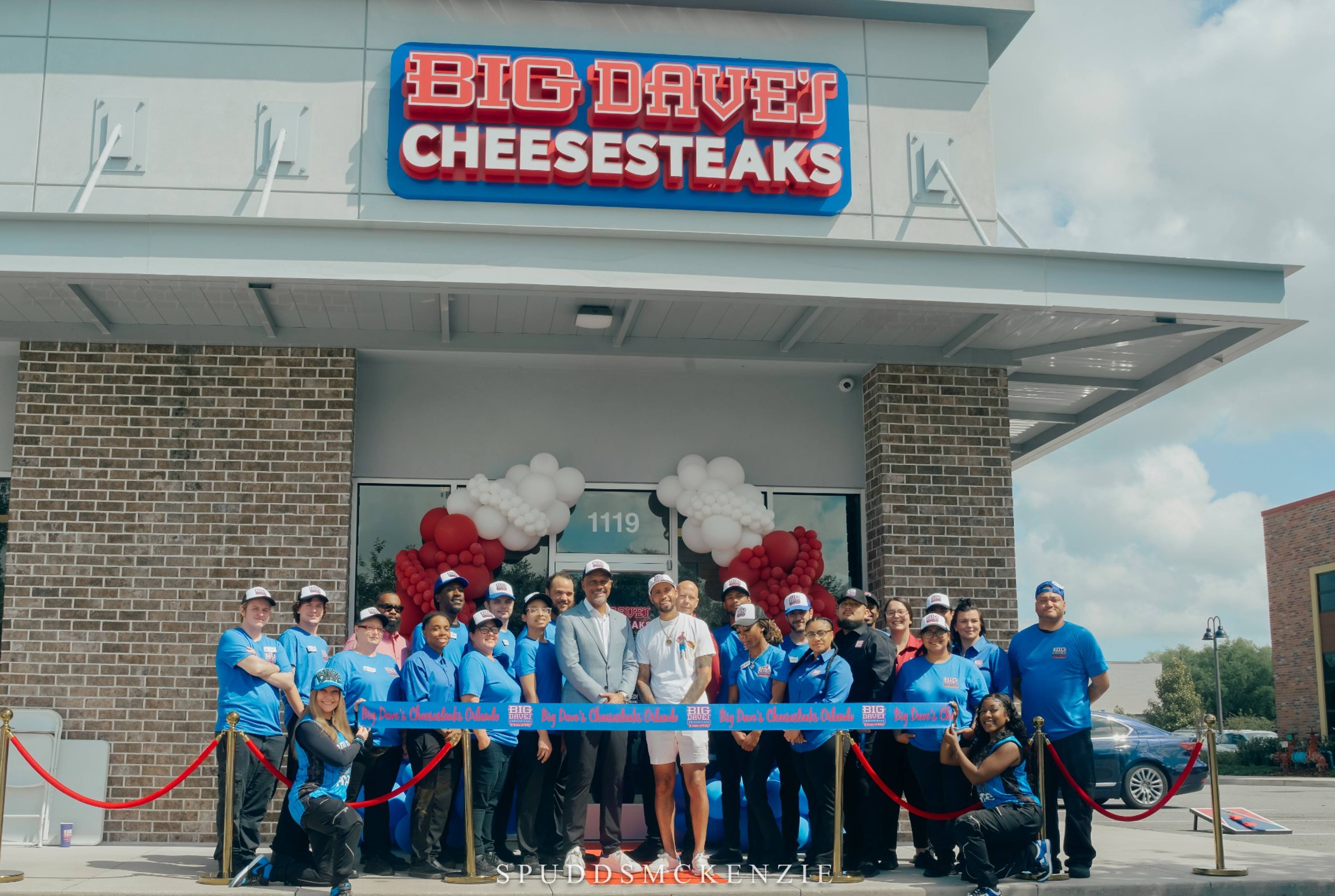 Big Dave's Cheesesteaks franchise owners and team at a grand-opening ribbon cutting
