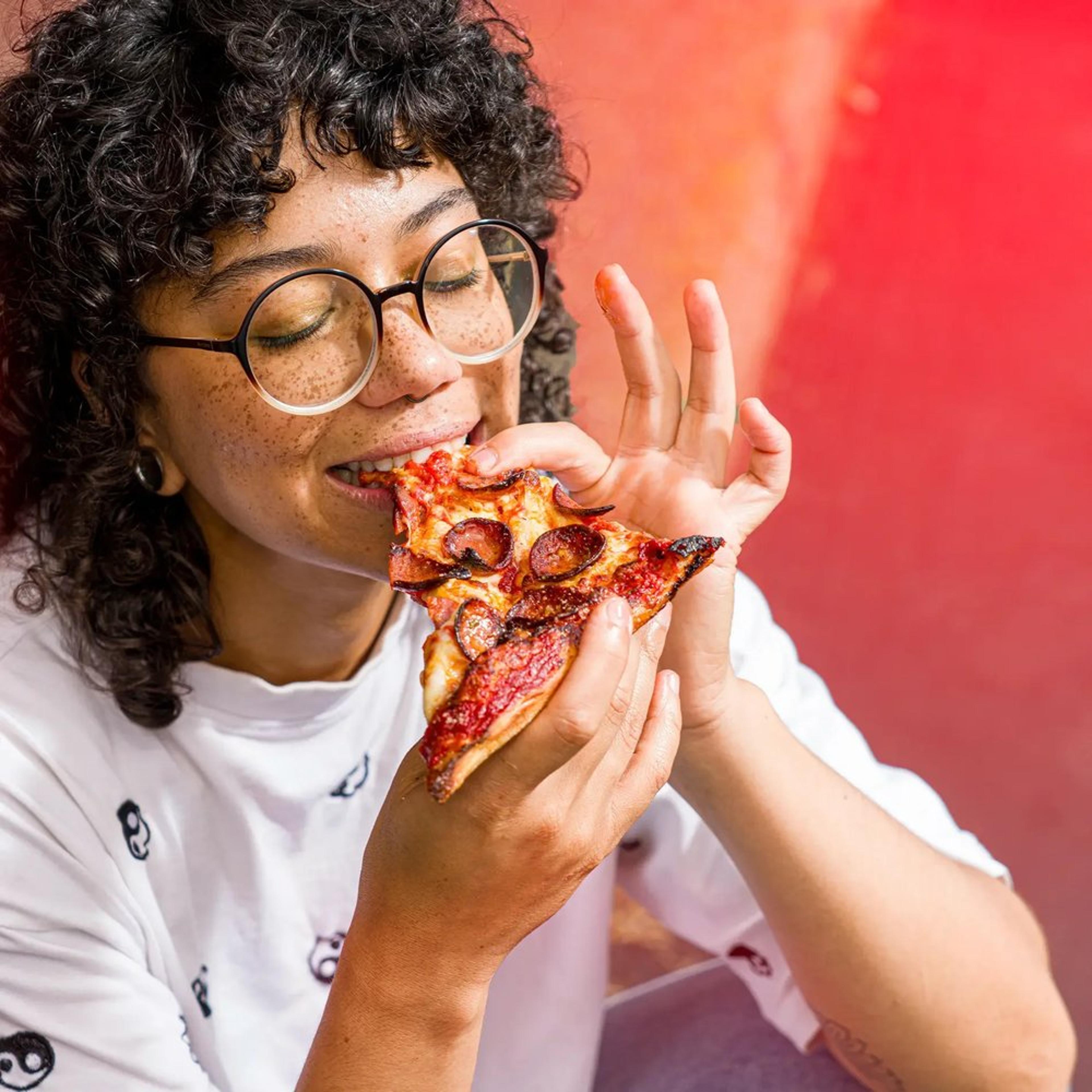 Enjoying a delicious slice of Buffalo style pizza from Picasso's Pizza.