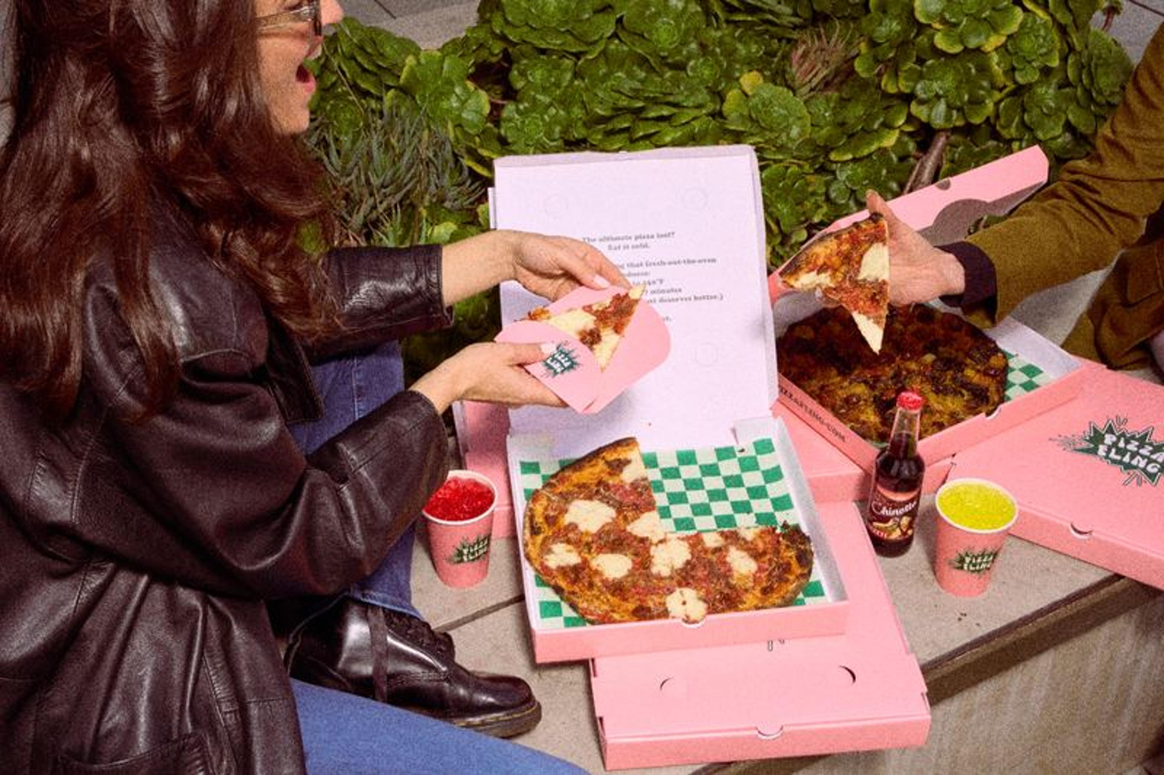 Pizza Fling crew serving pizza to go