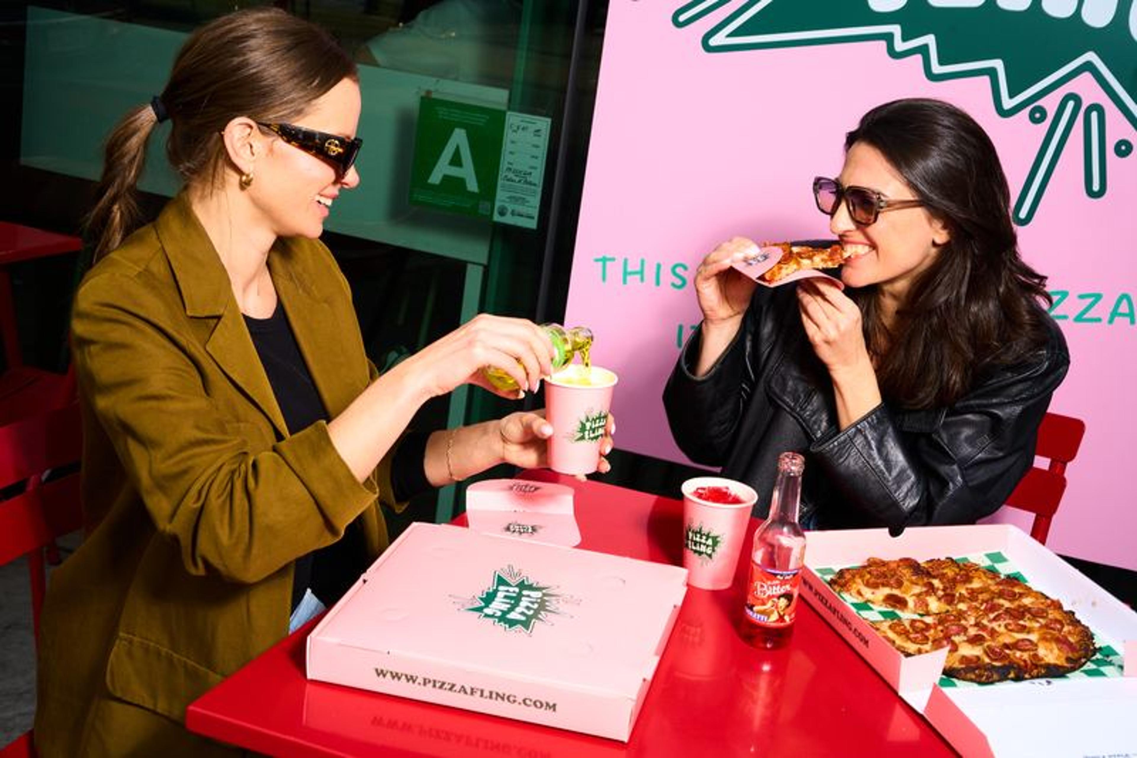 Friends sharing pizza in Santa Monica