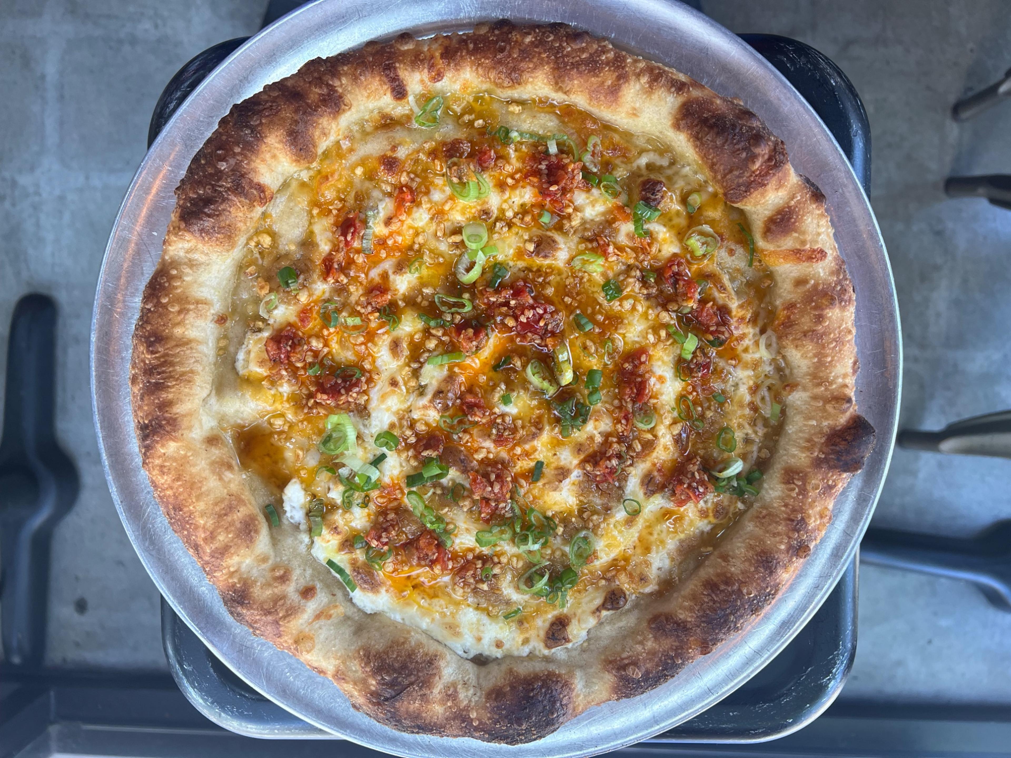 Dtown Pizzeria deep-dish pizza with chili oil, garlic, and scallions