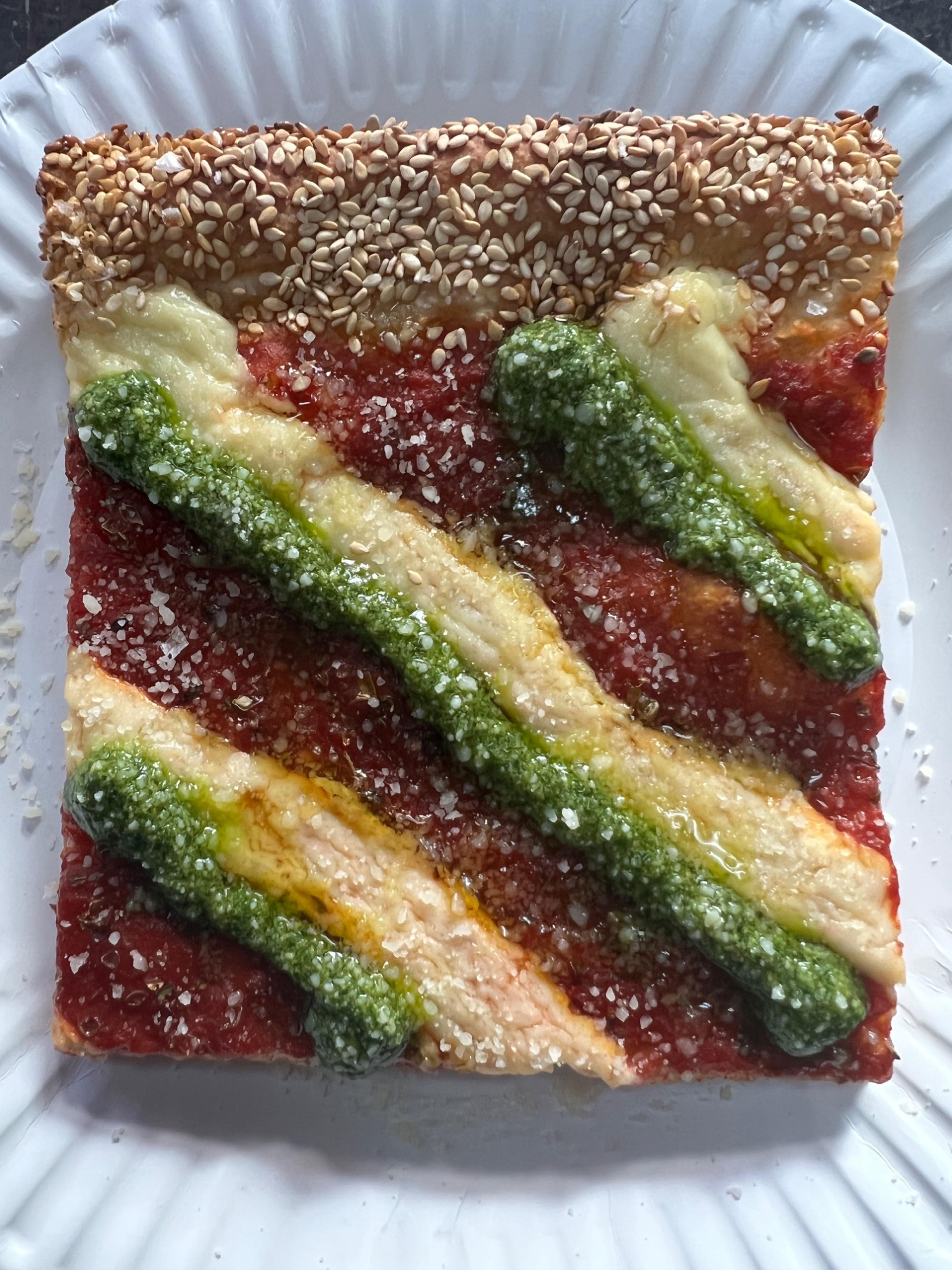 Dtown Pizzeria Detroit-style square slice with red sauce stripes, pesto, and sesame crust