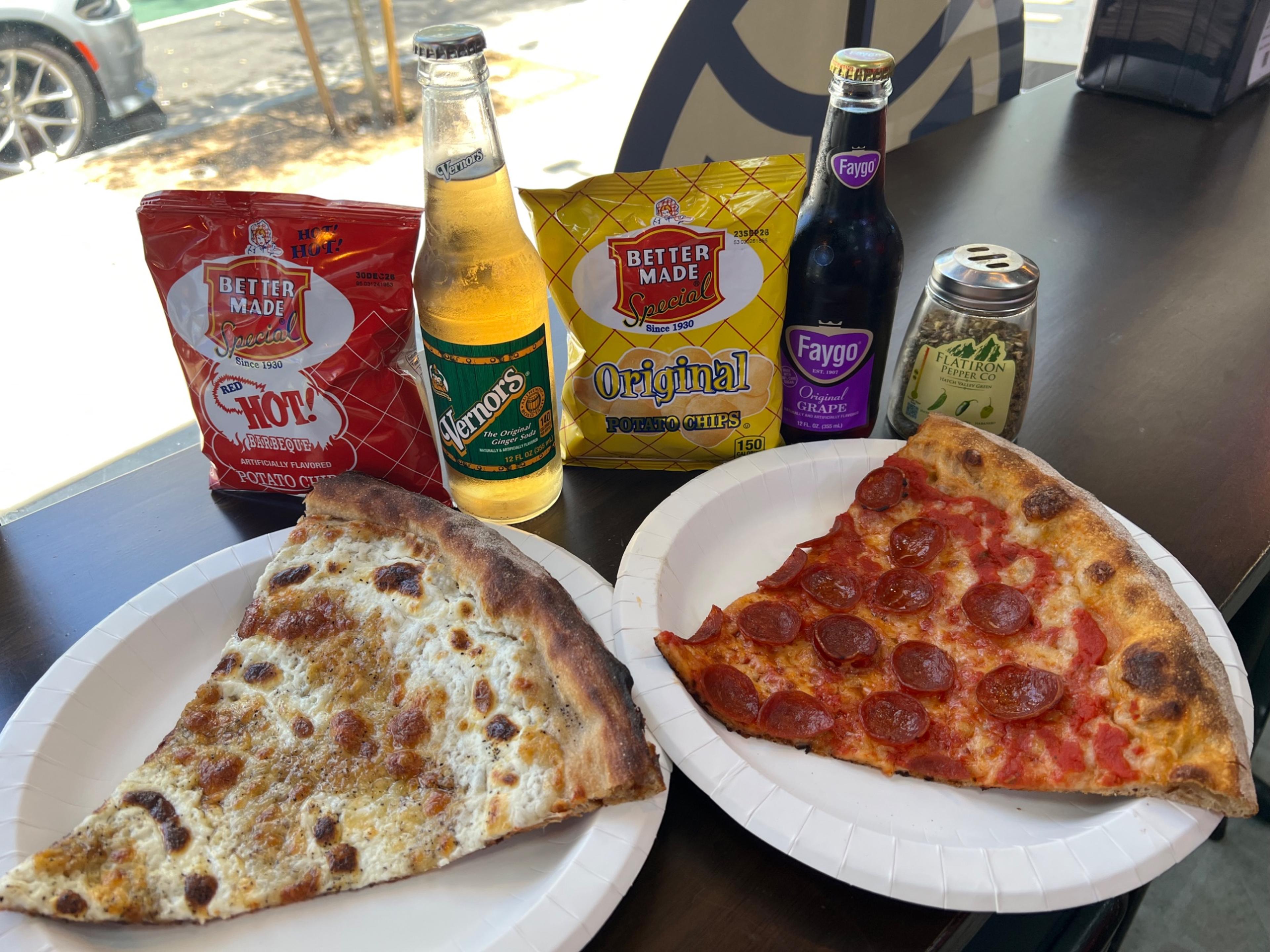 Dtown Pizzeria pizza slices with Detroit sodas and chips