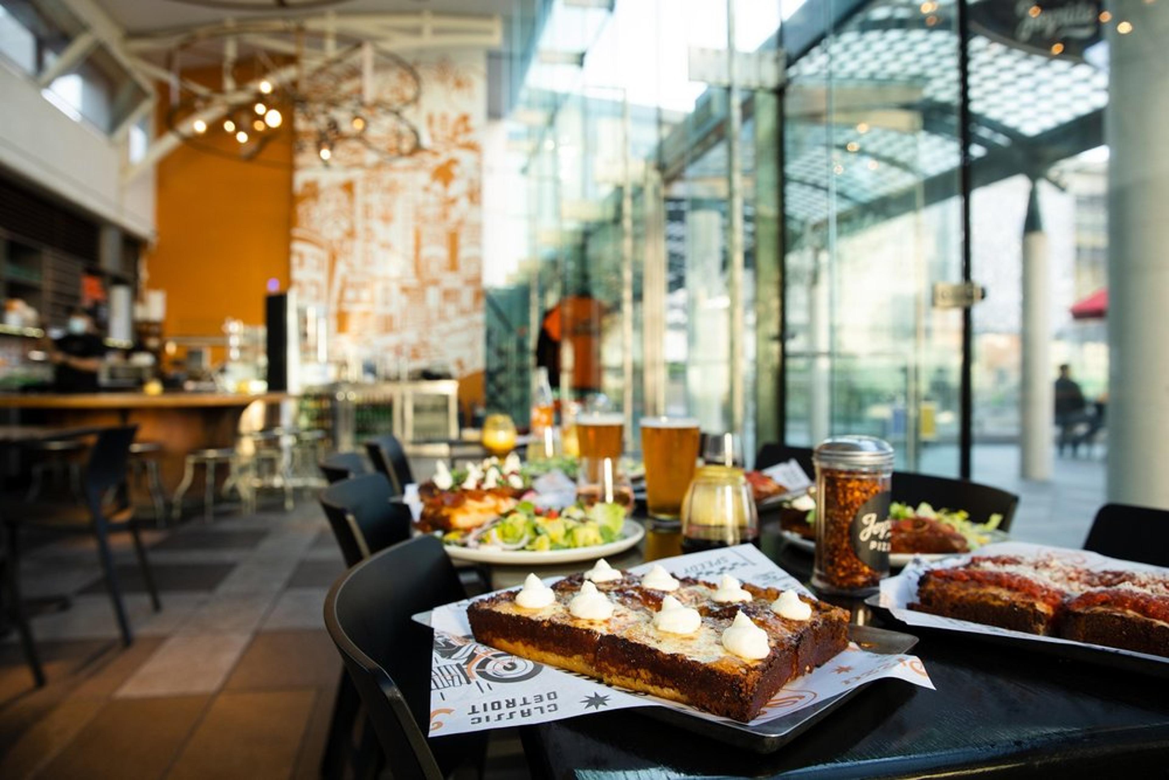 Joyride Pizza at Yerba Buena Gardens with a table set with pizzas, salads and drinks