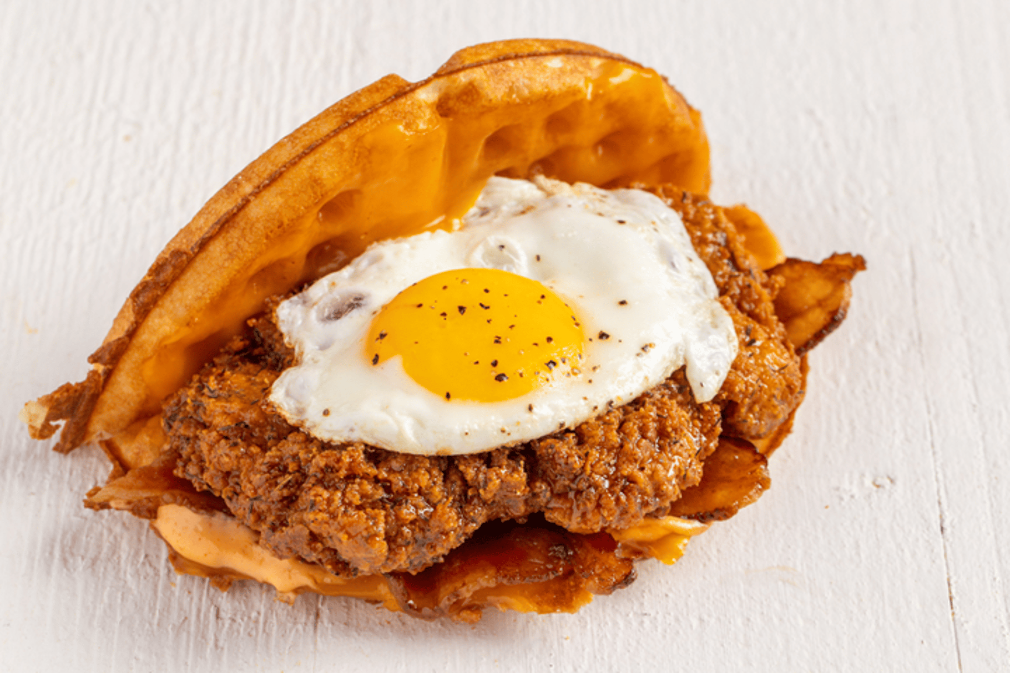 Bruxie waffle sandwich piled with crispy chicken