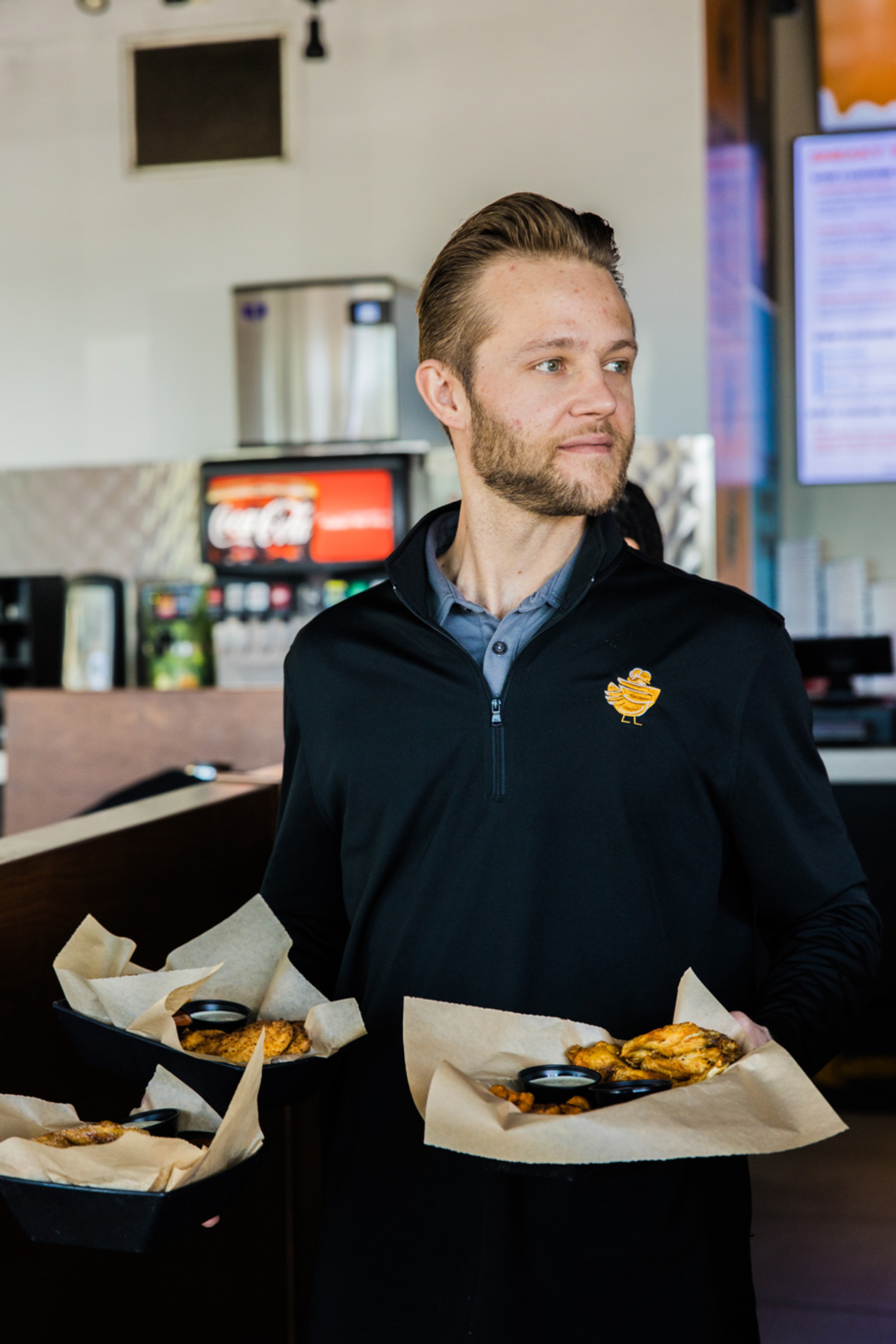 Sneakybird team member preparing oven-grilled chicken