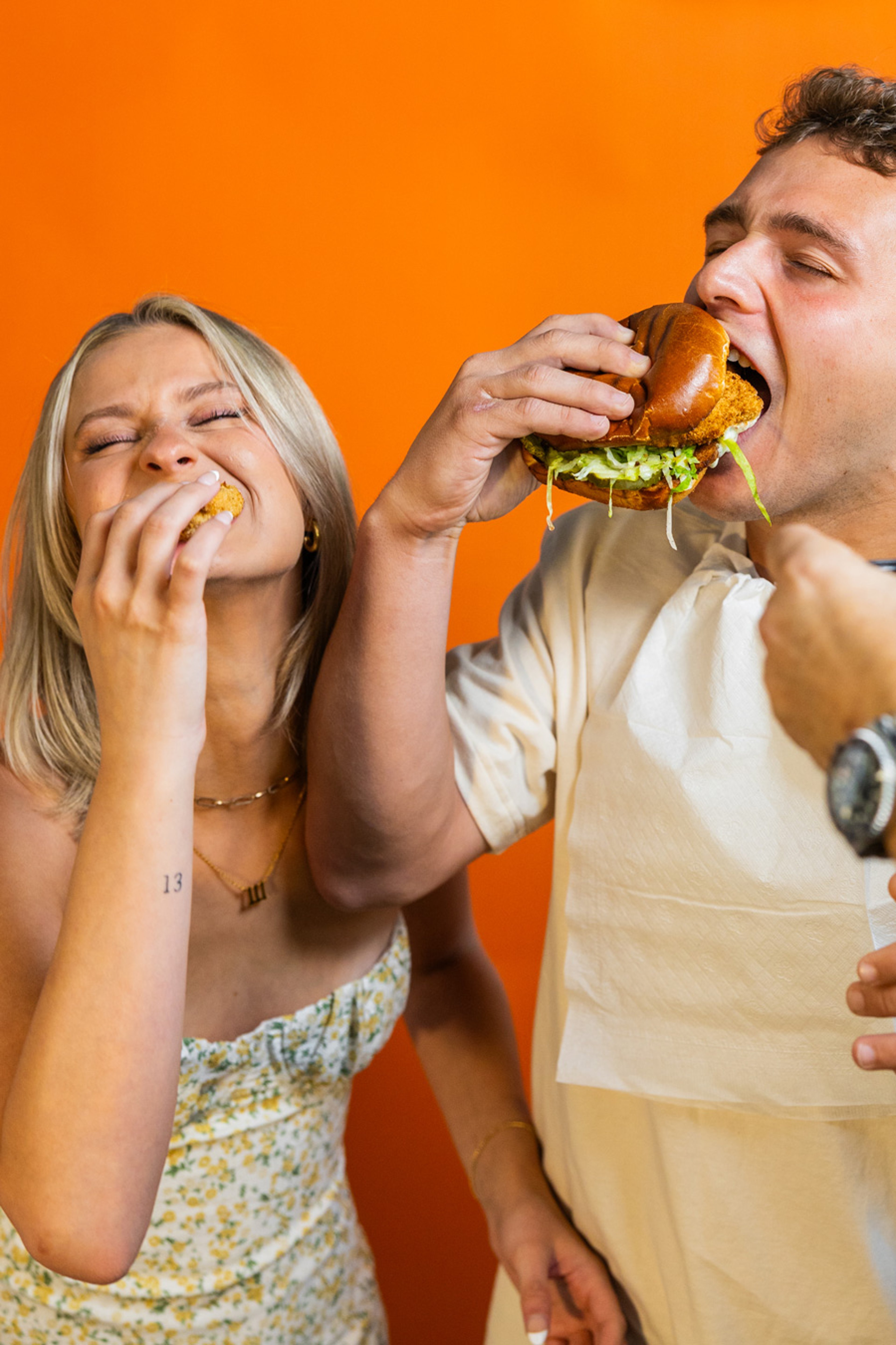 Two friends enjoying sneakybird chicken sandwiches