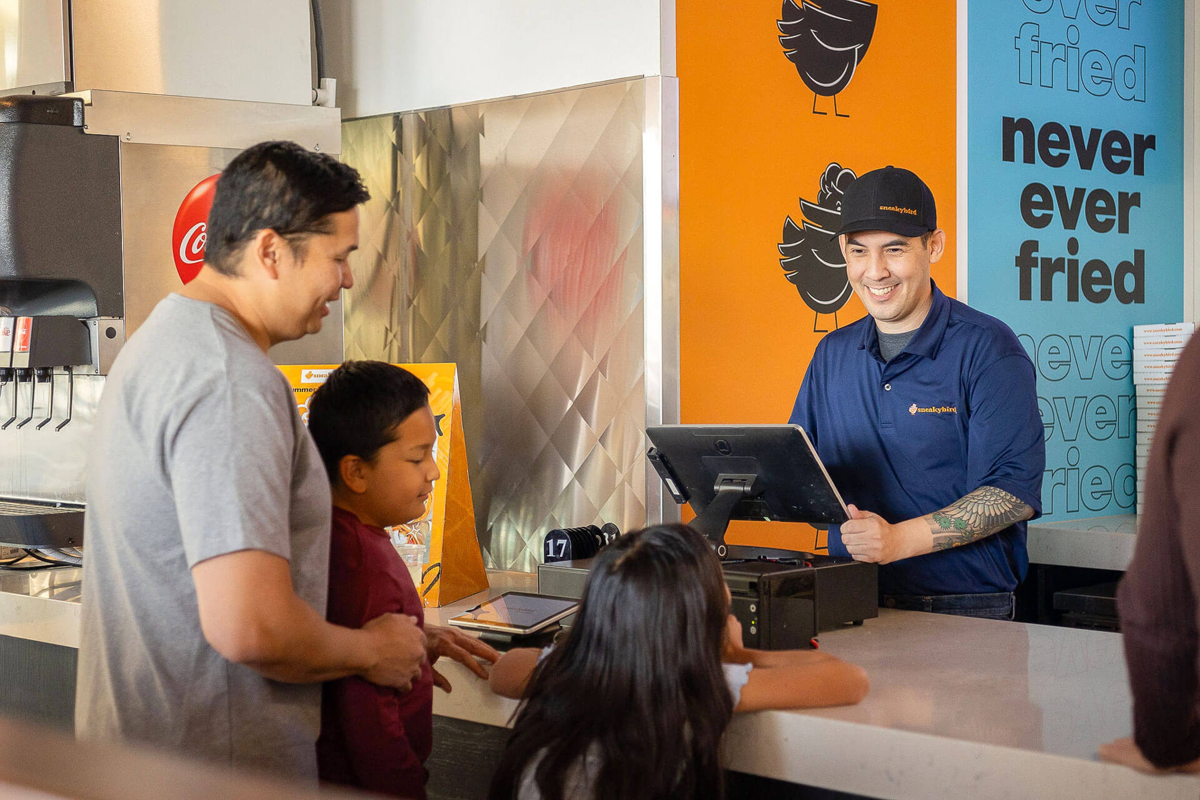 sneakybird team members serving guests at the counter
