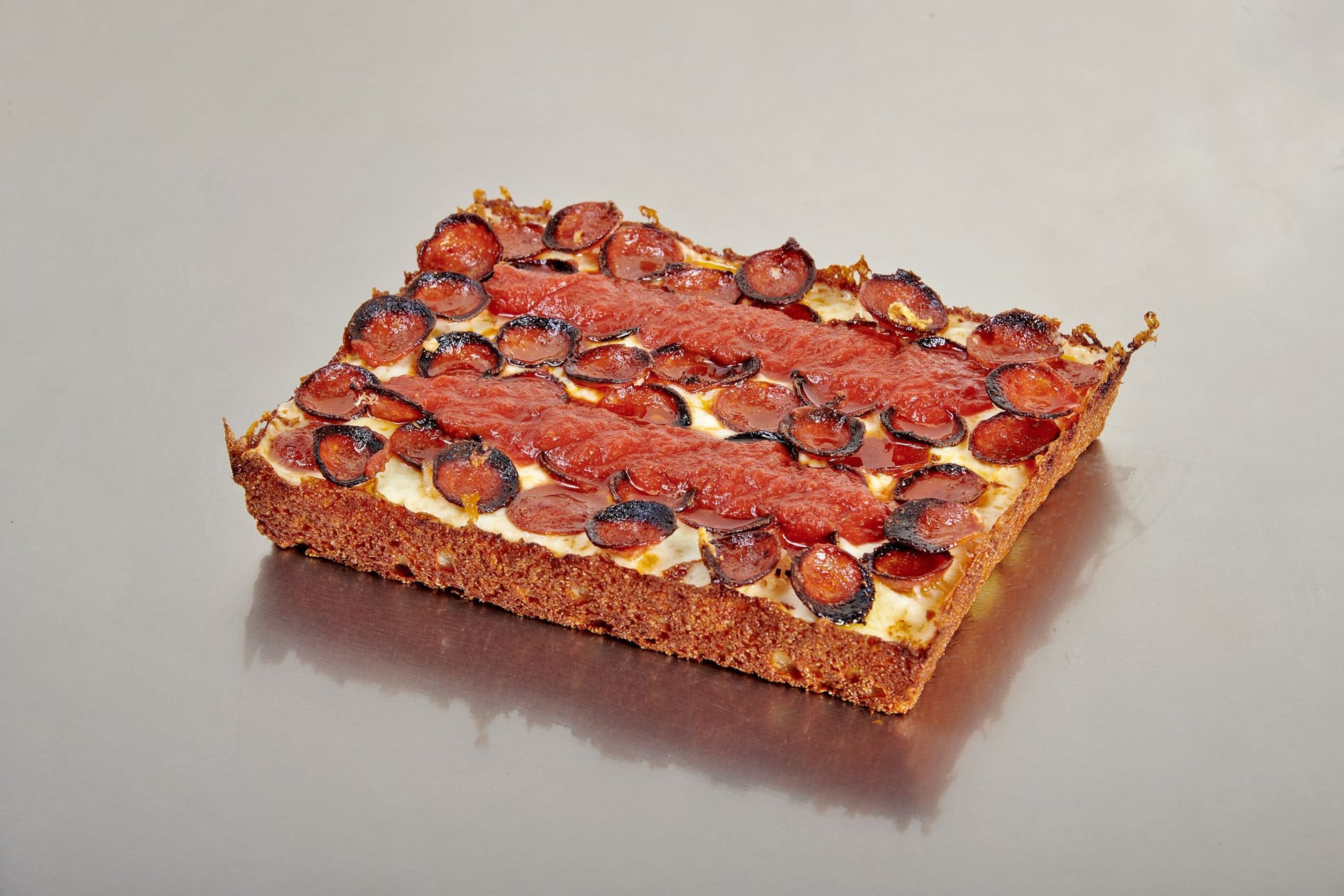 Detroit-style pizza freshly made at The Ria Pizzeria