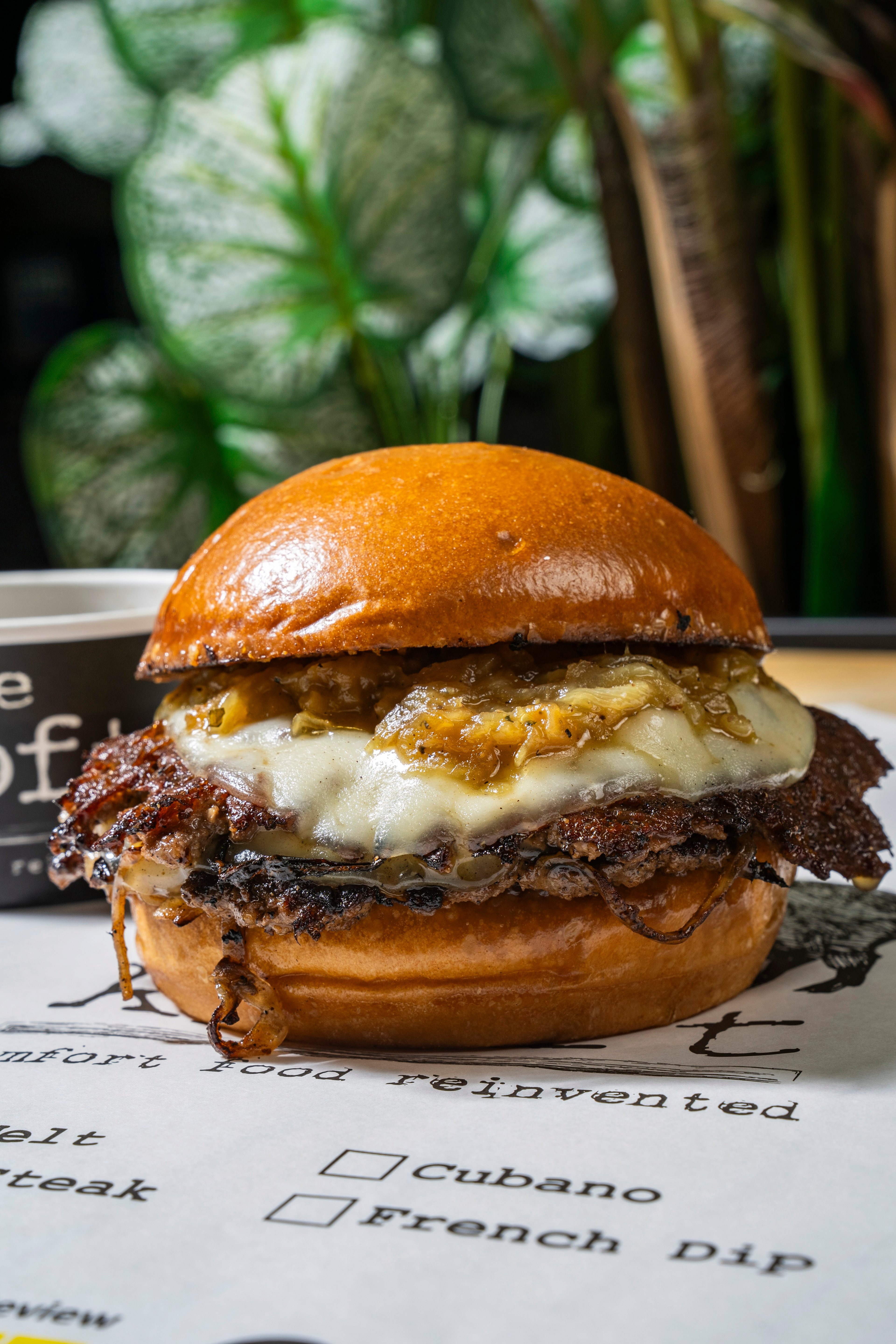 House-crafted burger with melted cheese and caramelized onions