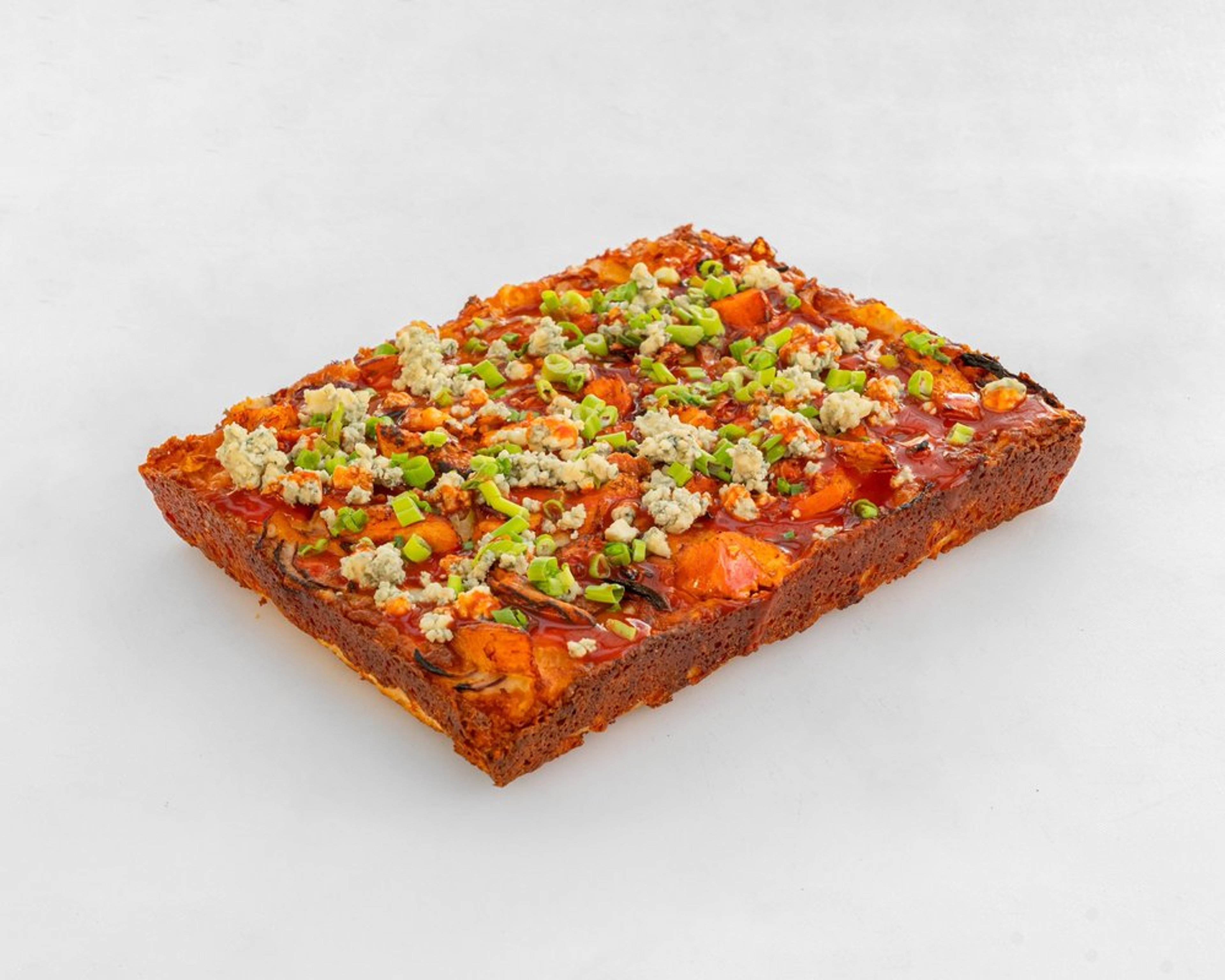 Buffalo Chicken pizza with hot sauce, red onion, blue cheese and scallions