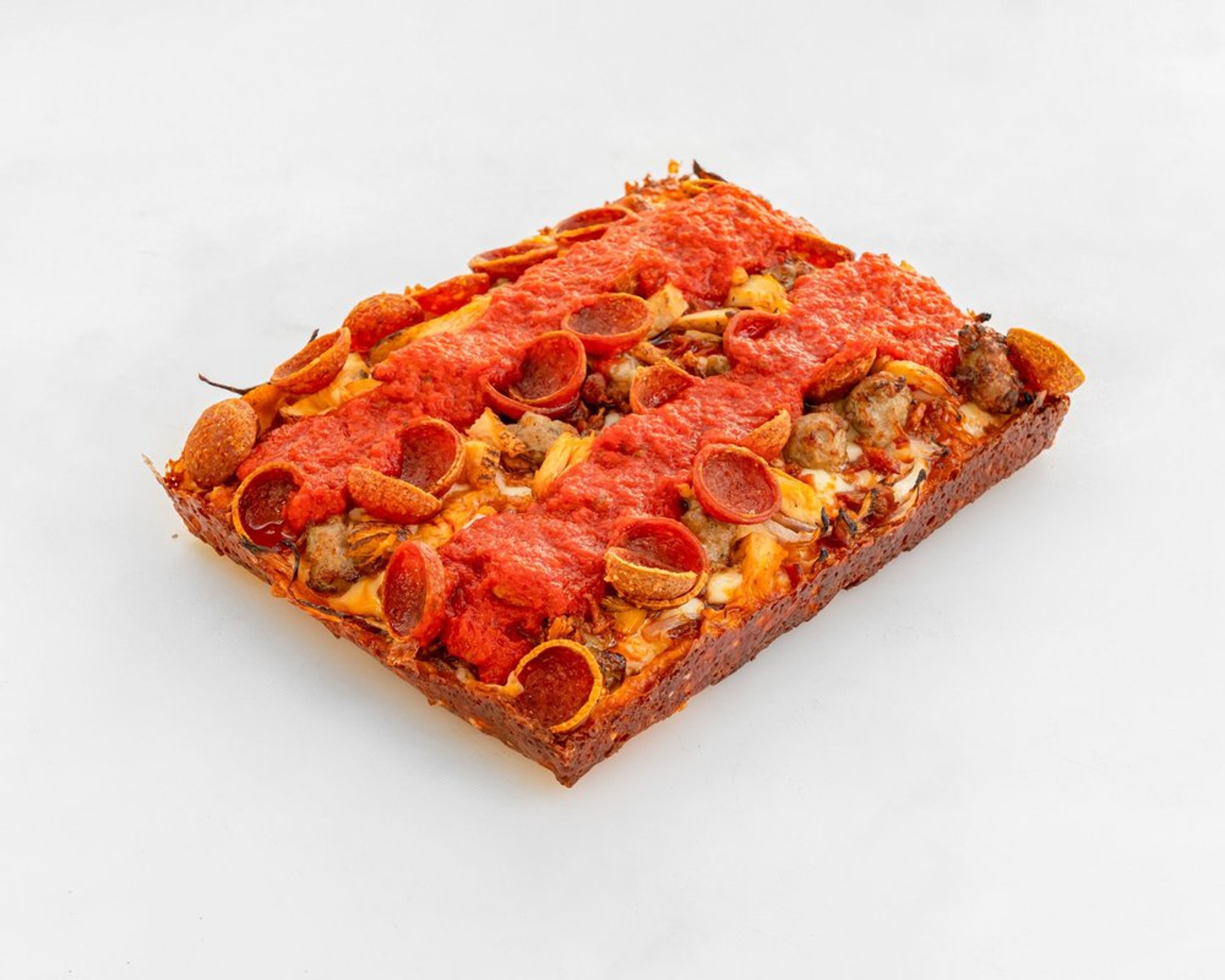Supreme pizza with pepperoni, bacon, chicken, sausage and red onion