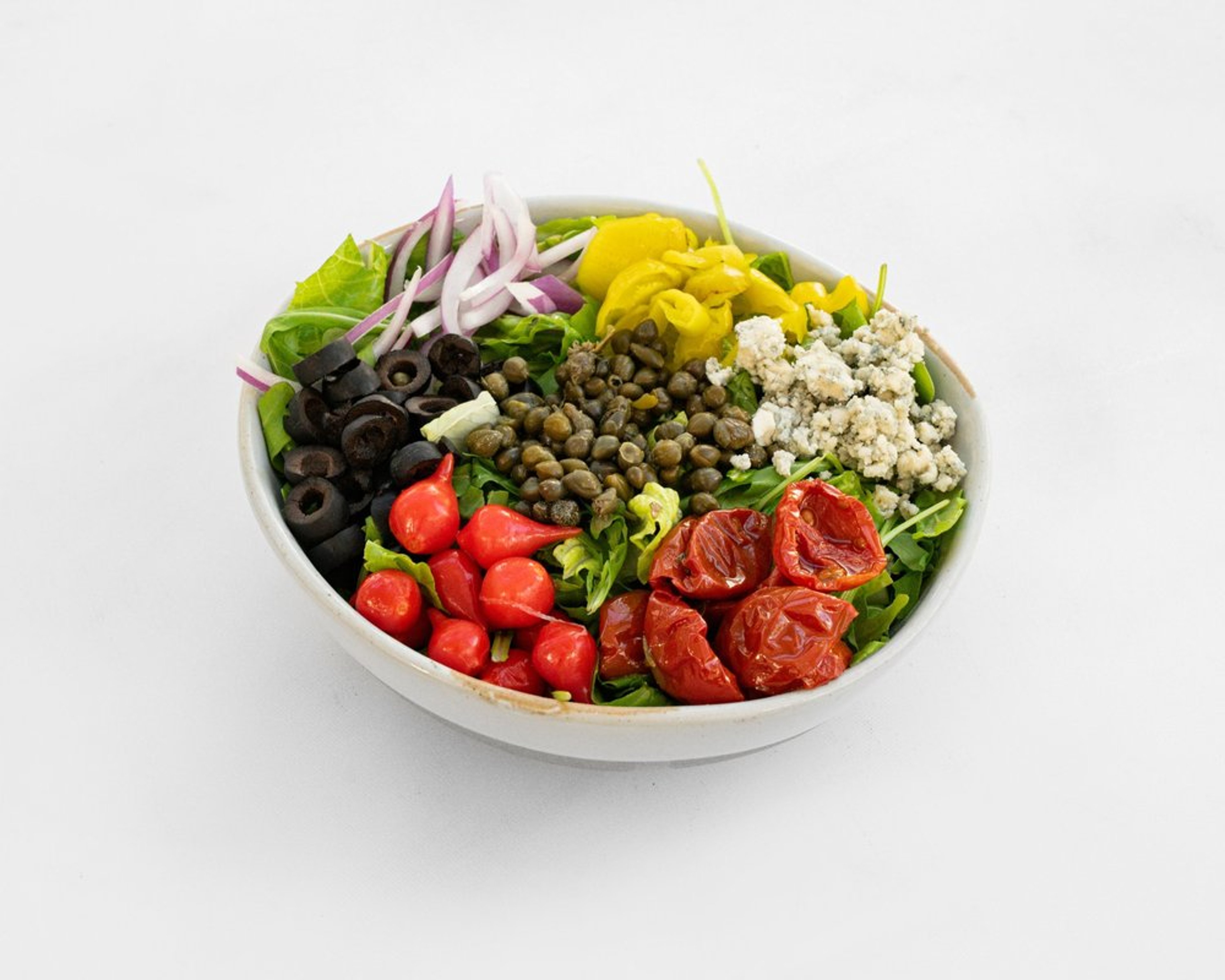 Antipasto salad with mixed greens, blue cheese, sun-dried tomatoes, olives and pepperoncini