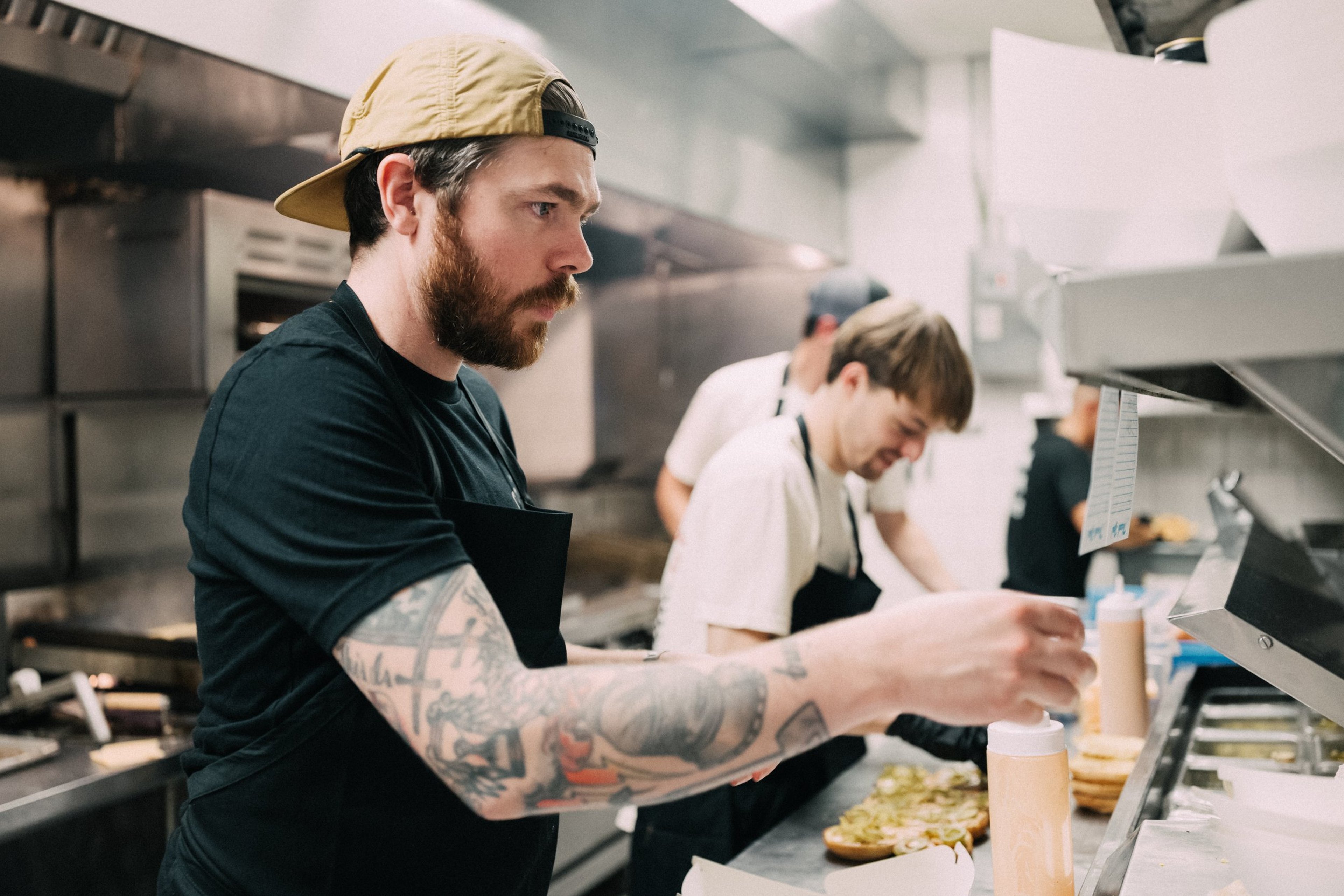 Phillip Frankland-Lee serves burgers at a Por Osos x NADC Burger event in Austin, TX.