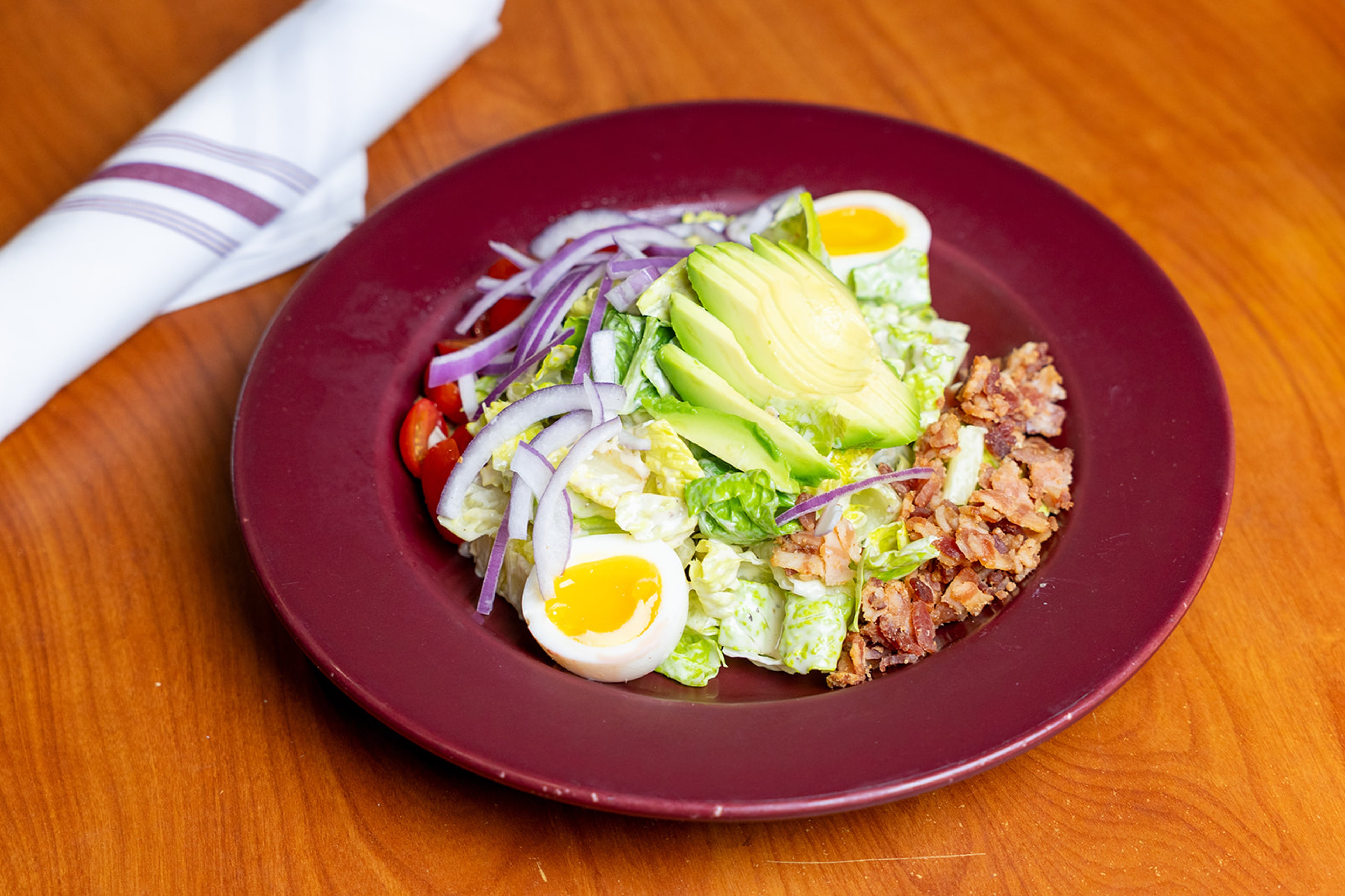 Italian Cobb salad with avocado, bacon and soft-boiled egg