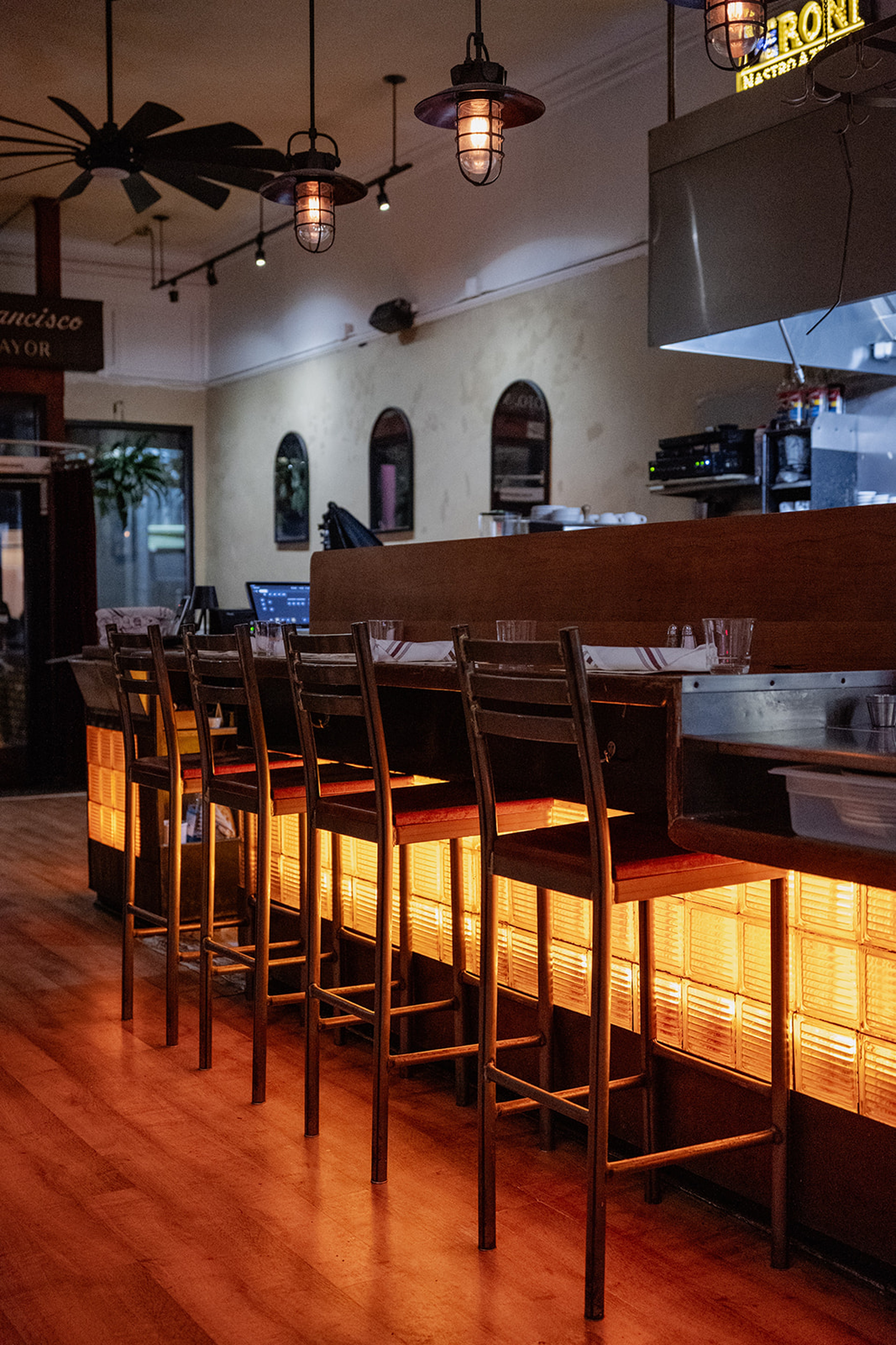 Rocco's Cafe counter seating with warm pendant lighting and bar stools