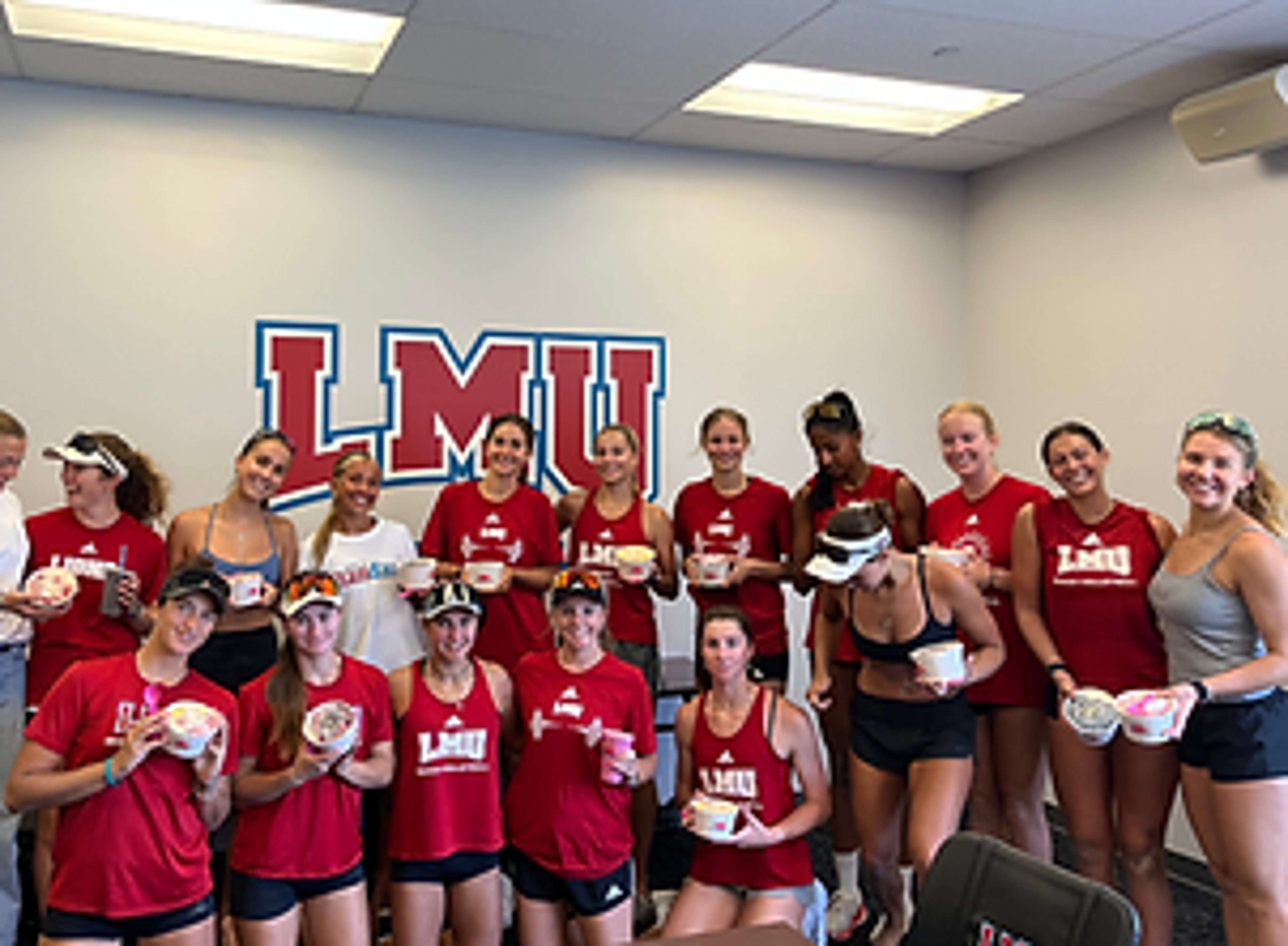 LMU athletes holding Paradise Bowls at a team gathering