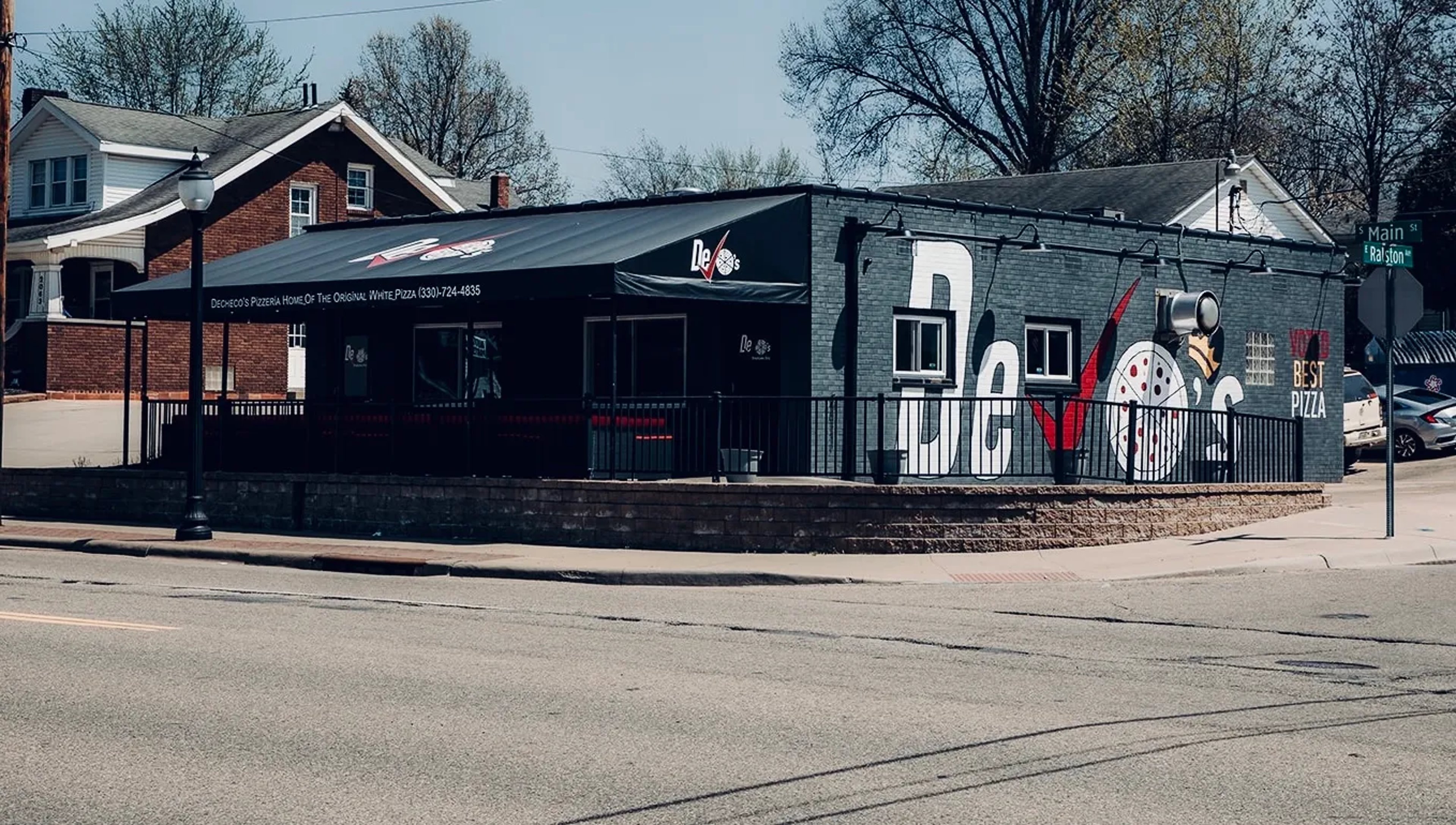 DeCheco's Pizzeria storefront at 2075 S Main St, Akron — the original Firestone Park shop with the DeCheco's mural