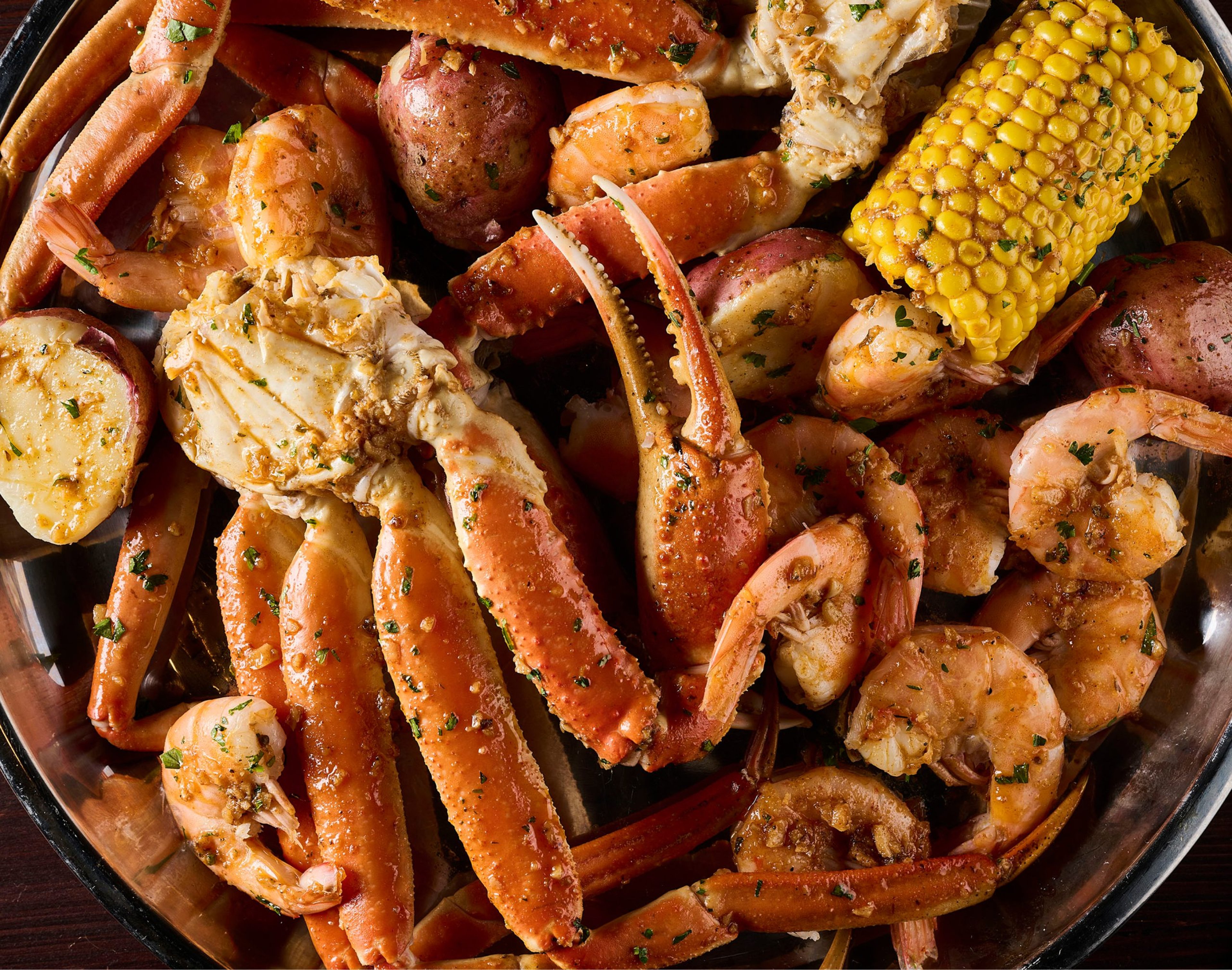Cajun seafood boil with crab legs, shrimp, corn and potatoes at Hook & Reel